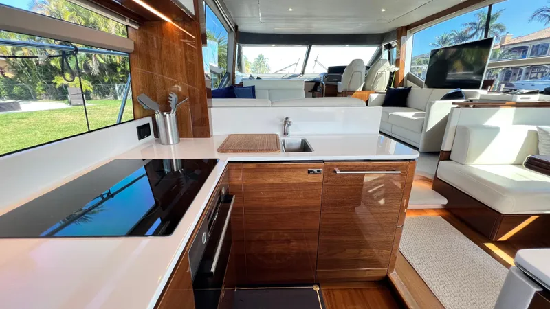 Sea Sea Elle Yacht Photos Pics Luxurious 2019 Princess F62 yacht interior with modern kitchen and spacious seating area.