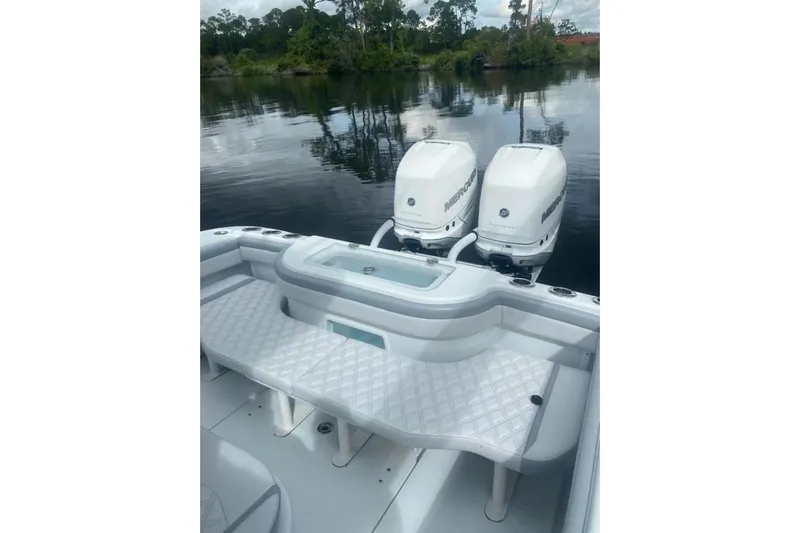 Lauren J Yacht Photos Pics 2022 Yellowfin 32 boat with dual Mercury engines on a calm lake.