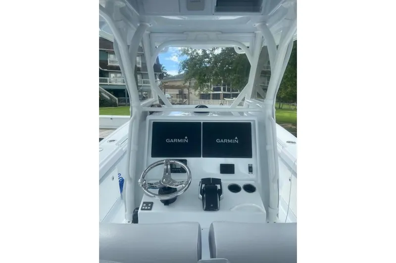 Lauren J Yacht Photos Pics 2022 Yellowfin 32 boat dashboard with Garmin displays and steering wheel.