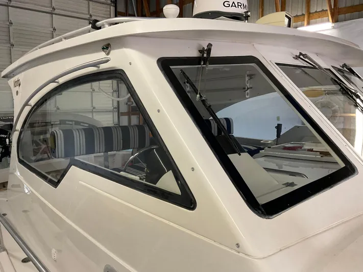  Yacht Photos Pics 2000 Mainship Pilot boat cabin with striped interior, docked indoors.