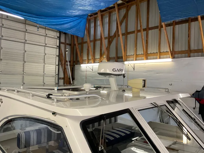  Yacht Photos Pics 2000 Mainship Pilot boat in storage, featuring radar and striped interior seating.