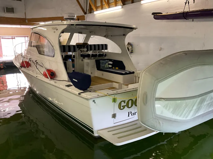  Yacht Photos Pics 2000 Mainship Pilot boat docked indoors, featuring open cockpit and seating.