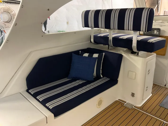  Yacht Photos Pics 2000 Mainship Pilot boat interior with striped navy seating and wooden flooring.