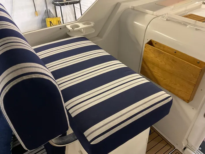  Yacht Photos Pics 2000 Mainship Pilot boat interior with striped seating and wooden storage.