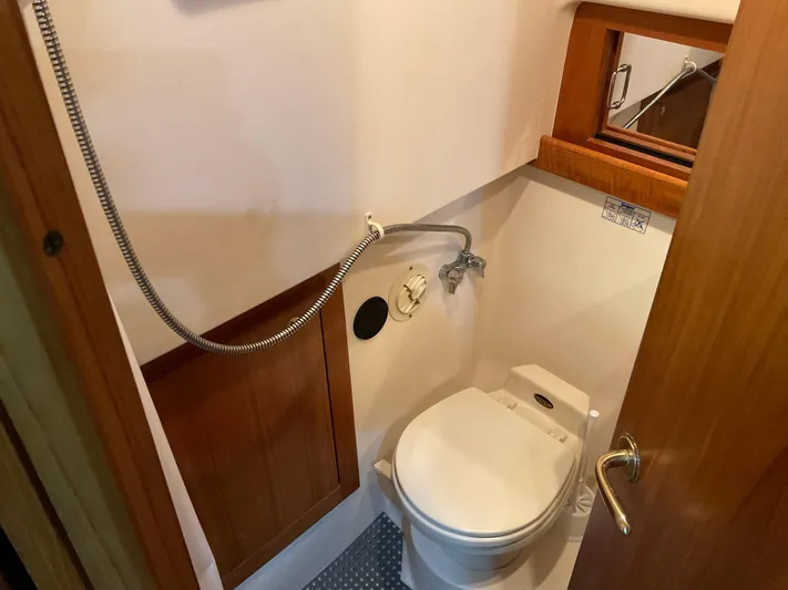  Yacht Photos Pics Compact bathroom in 2000 Mainship Pilot boat with toilet and showerhead.