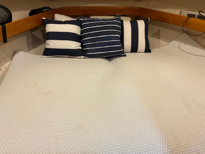  Yacht Photos Pics Cozy cabin bed with striped pillows on a 2000 Mainship Pilot boat.
