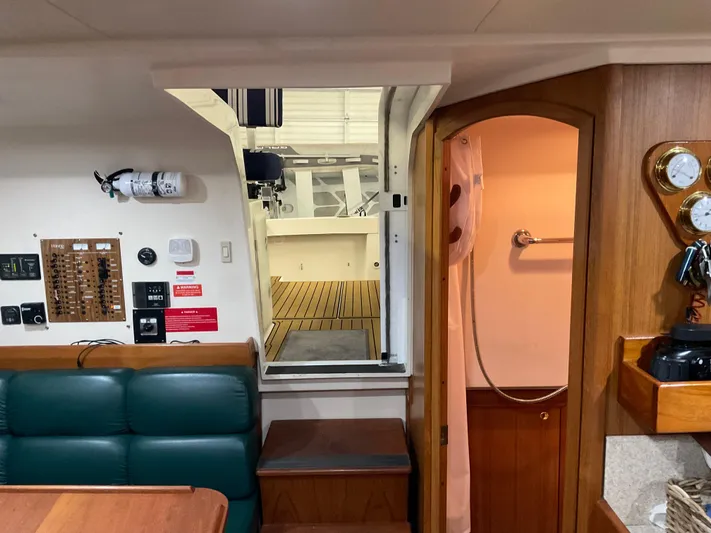  Yacht Photos Pics 2000 Mainship Pilot interior with seating, control panel, and wooden cabinetry.