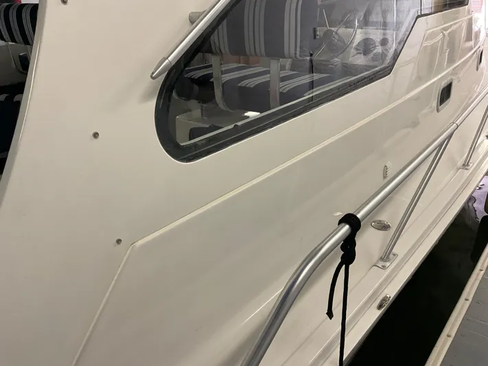  Yacht Photos Pics 2000 Mainship Pilot boat side view with window and railing detail.