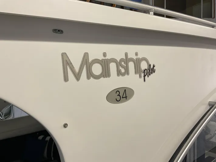  Yacht Photos Pics 2000 Mainship Pilot 34 boat side view with logo and model number.