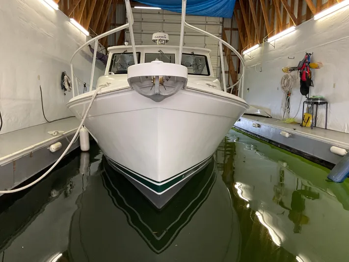  Yacht Photos Pics 2000 Mainship Pilot boat docked in indoor marina with green water.
