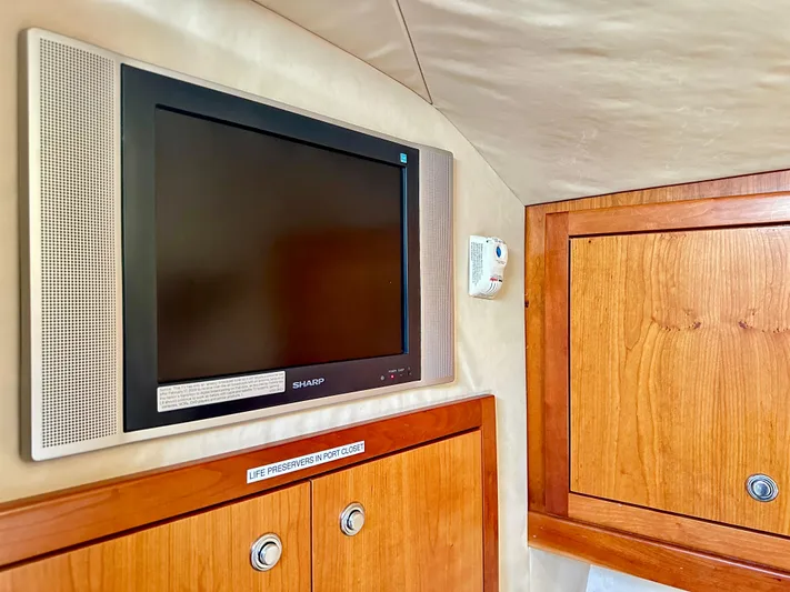 Steamer Yacht Photos Pics Interior of 2008 Albemarle 410 Express Fisherman with TV and wooden cabinetry.