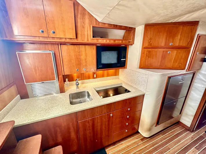 Steamer Yacht Photos Pics 2008 Albemarle 410 Express Fisherman yacht interior kitchen with wood cabinetry and modern appliances.