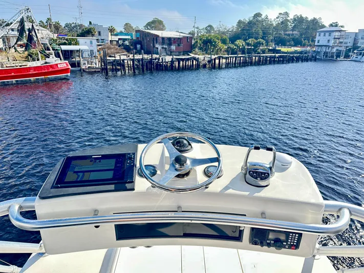Steamer Yacht Photos Pics Helm of 2008 Albemarle 410 Express Fisherman overlooking a scenic waterfront.
