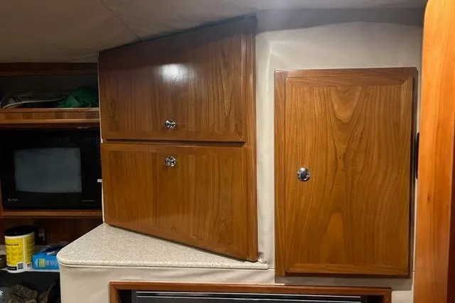 Steamer Yacht Photos Pics 2008 Albemarle 410 Express Fisherman interior with wooden cabinets and storage.