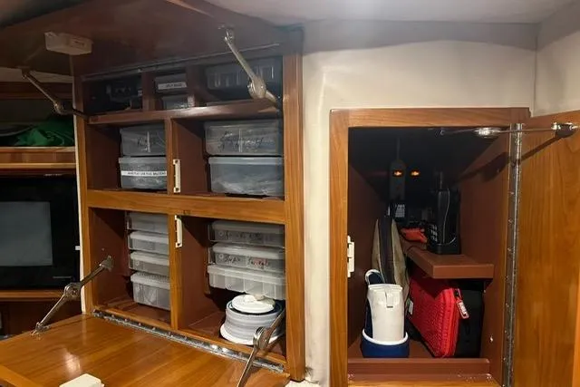 Steamer Yacht Photos Pics Interior storage of 2008 Albemarle 410 Express Fisherman with organized shelves and cabinets.