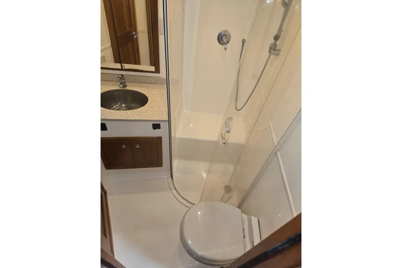 Steamer Yacht Photos Pics 2008 Albemarle 410 Express Fisherman bathroom with shower, sink, and toilet.