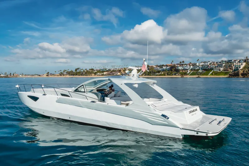 Catch & Release Yacht Photos Pics Luxurious 2017 Custom 60 yacht cruising near scenic coastal homes under a blue sky.