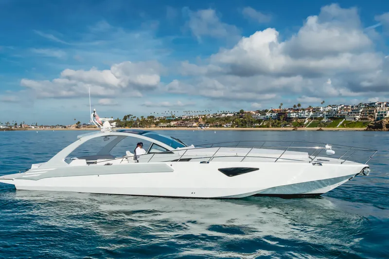 Catch & Release Yacht Photos Pics Luxurious 2017 Custom 60 yacht cruising near scenic coastal homes under a blue sky.