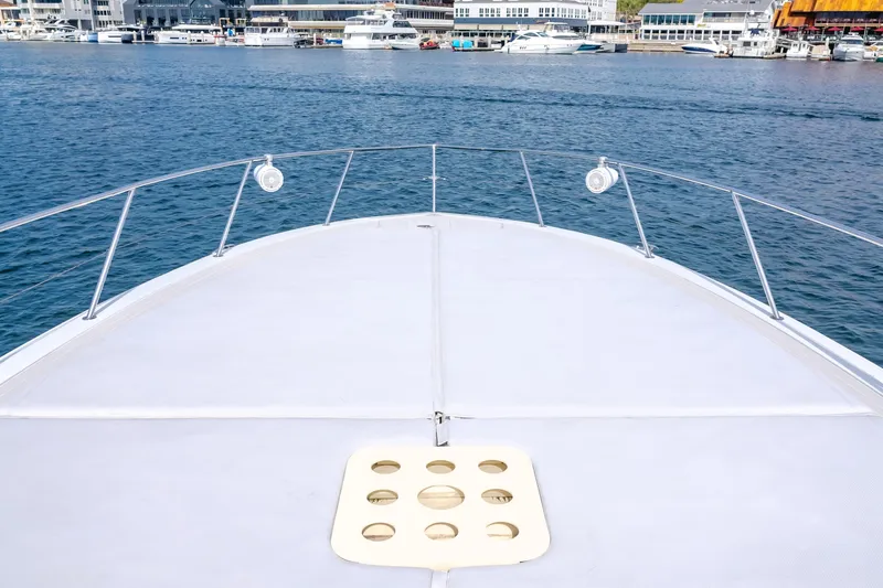 Catch & Release Yacht Photos Pics Bow of a 2017 Custom 60 yacht overlooking a marina with boats.