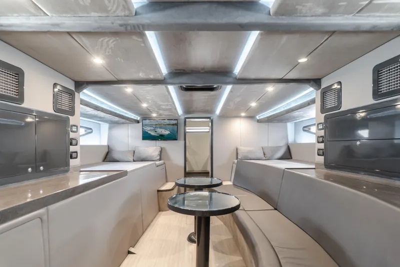 Catch & Release Yacht Photos Pics Luxurious interior of a 2017 Custom 60 yacht with modern seating and ambient lighting.