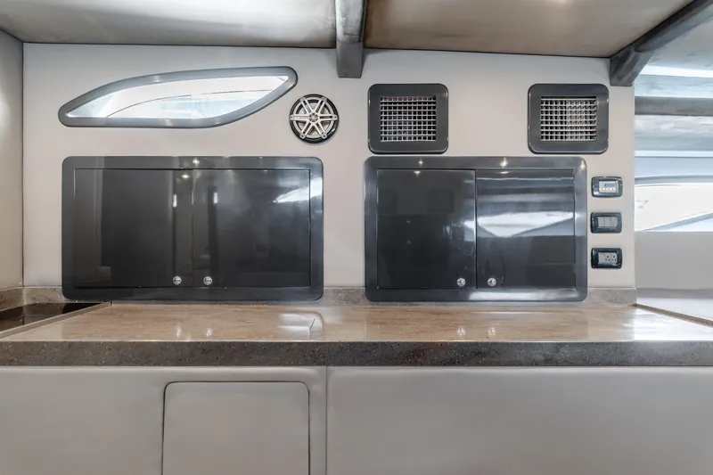 Catch & Release Yacht Photos Pics Modern yacht interior with sleek cabinets, speaker, and control panels, Custom model 60, 2017.