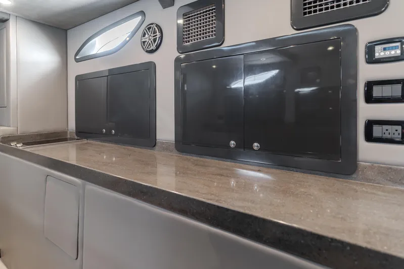 Catch & Release Yacht Photos Pics Modern interior of a 2017 Custom 60 vehicle with sleek cabinets and control panels.