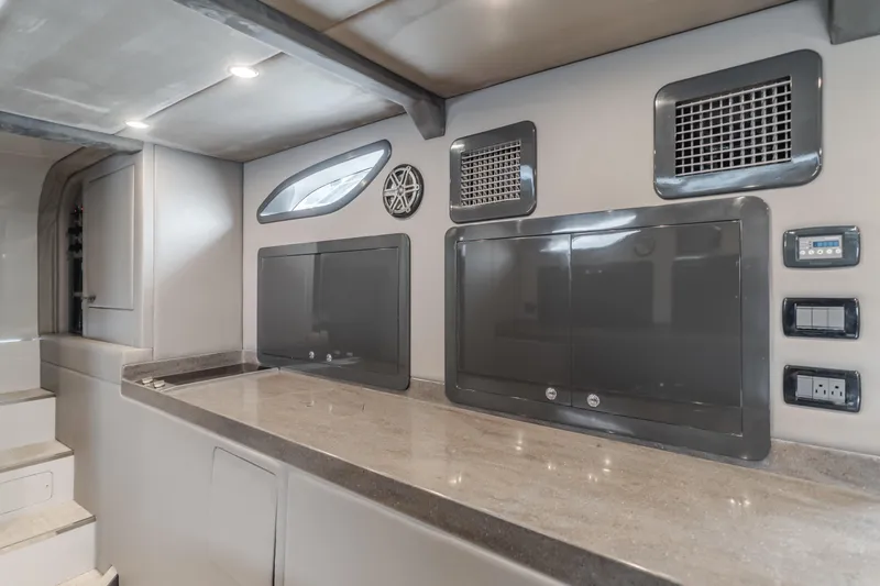 Catch & Release Yacht Photos Pics Modern interior of a 2017 Custom 60 yacht with sleek design and control panels.