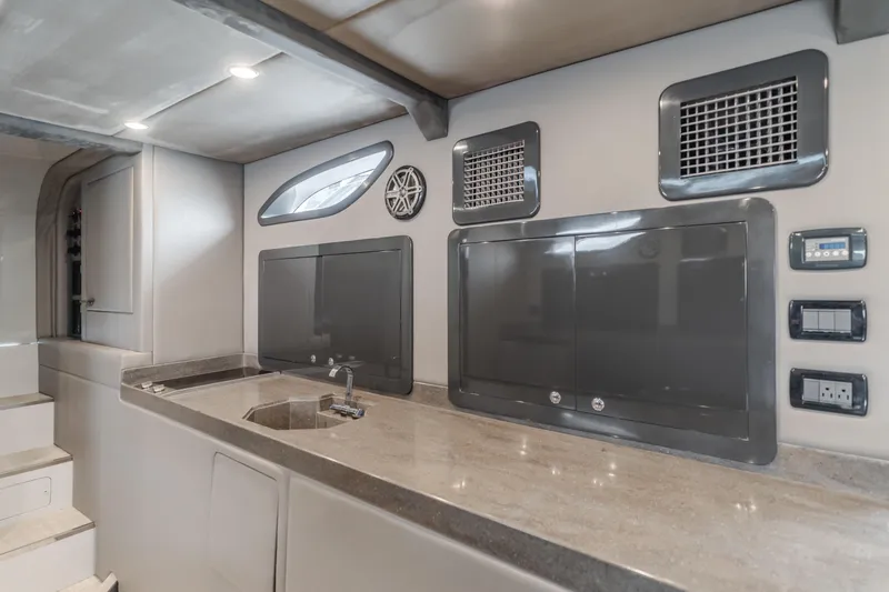 Catch & Release Yacht Photos Pics Modern yacht interior with sleek kitchen design, featuring stainless steel appliances and minimalist decor, 2017.