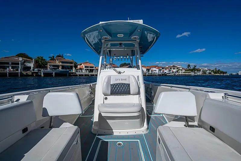 Livy Rose Yacht Photos Pics 2021 Cobia 320 Center Console boat on water with luxury seating and waterfront homes.