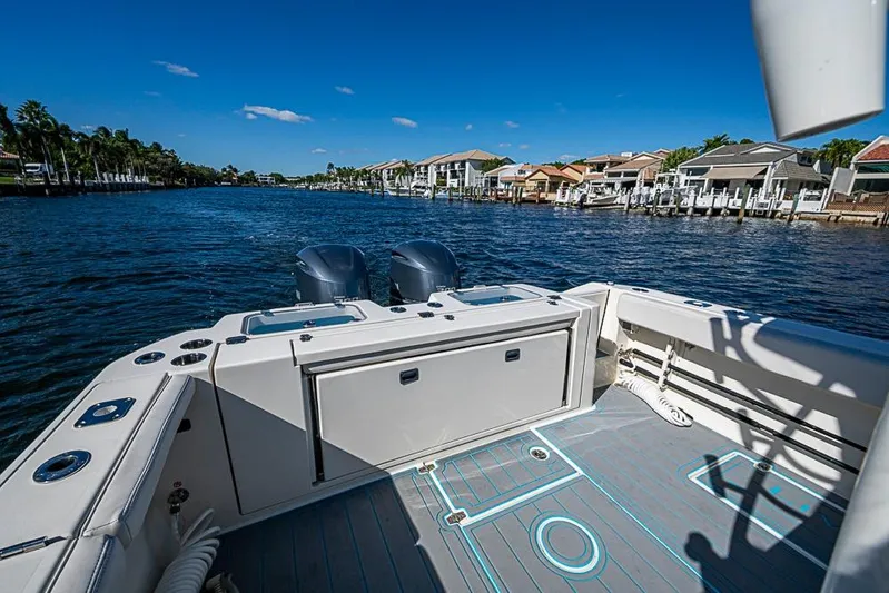 Livy Rose Yacht Photos Pics 2021 Cobia 320 Center Console boat on a scenic waterfront with clear blue skies.