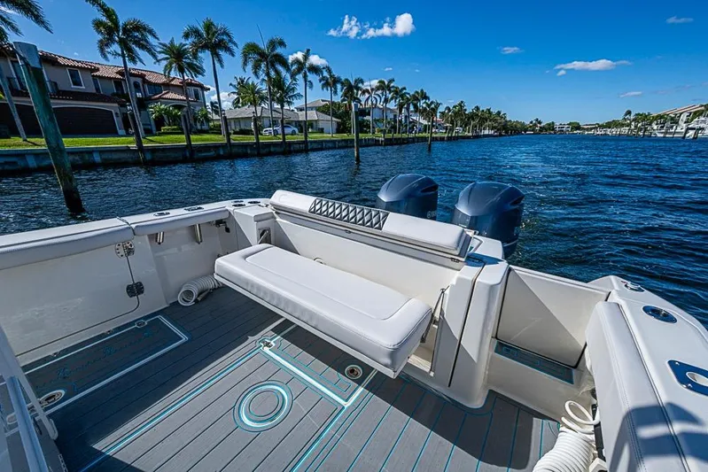 Livy Rose Yacht Photos Pics 2021 Cobia 320 Center Console boat on a sunny waterfront with palm trees.