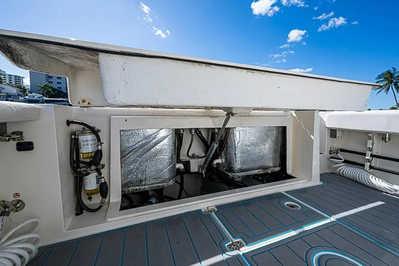 Livy Rose Yacht Photos Pics 2021 Cobia 320 Center Console boat with open storage compartment, blue sky background.