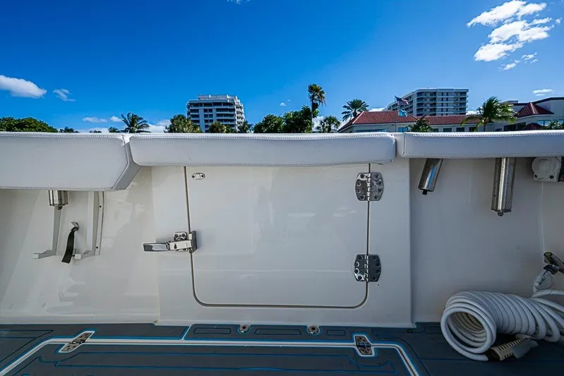 Livy Rose Yacht Photos Pics 2021 Cobia 320 Center Console boat interior with blue sky and buildings in background.