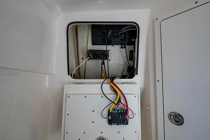 Livy Rose Yacht Photos Pics Electrical panel inside a 2021 Cobia 320 Center Console boat, showing wiring and components.