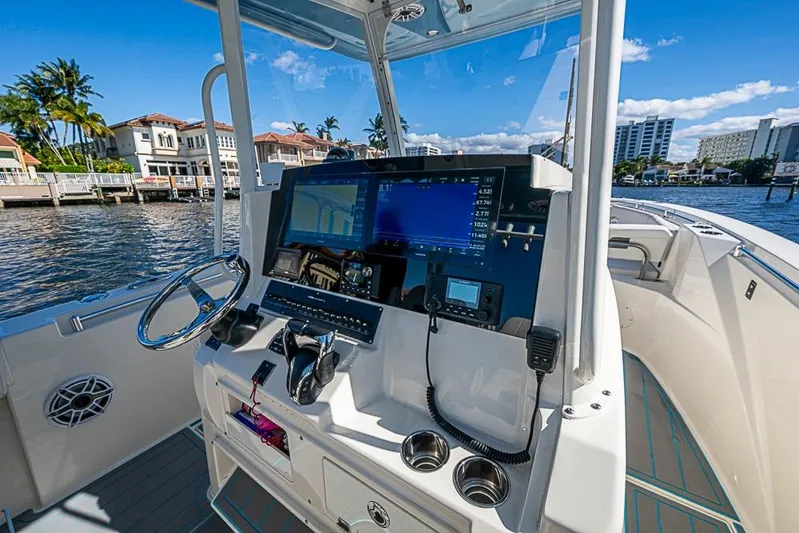 Livy Rose Yacht Photos Pics 2021 Cobia 320 Center Console boat dashboard with navigation screens and controls.