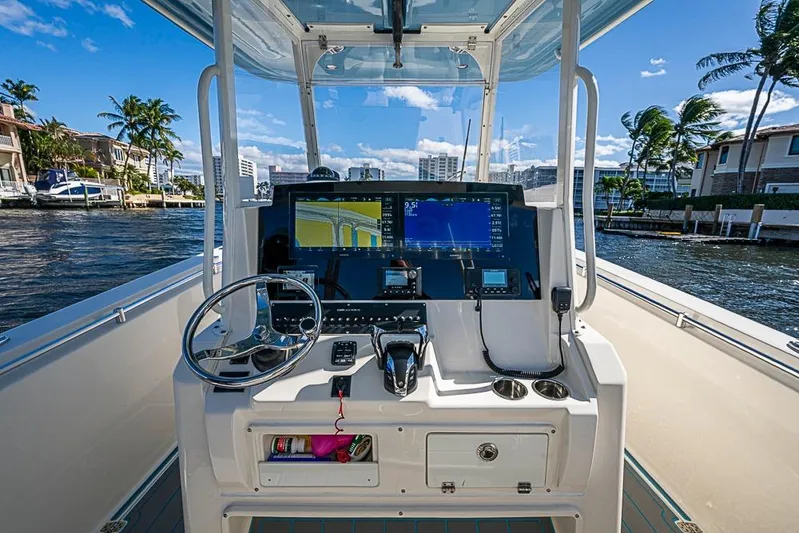 Livy Rose Yacht Photos Pics 2021 Cobia 320 Center Console boat dashboard with navigation screens and steering wheel.