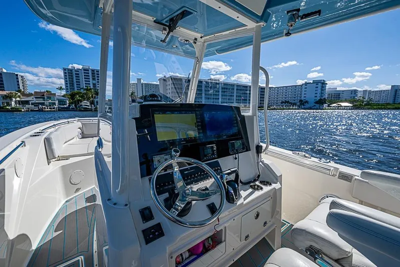 Livy Rose Yacht Photos Pics 2021 Cobia 320 Center Console boat interior with modern dashboard on a sunny day.