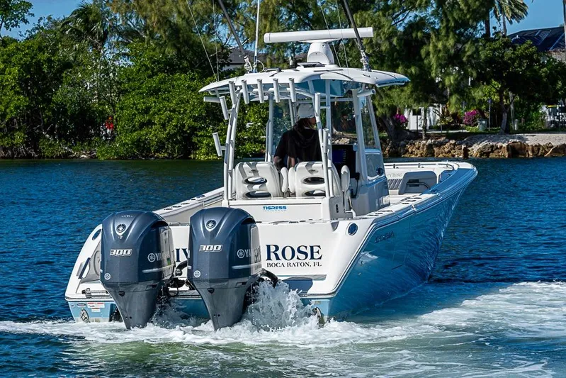 Livy Rose Yacht Photos Pics 2021 Cobia 320 Center Console boat cruising on water with twin Yamaha engines.