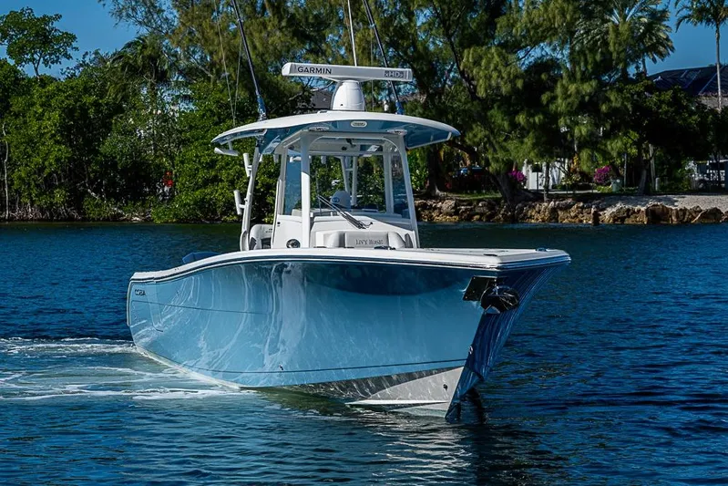 Livy Rose Yacht Photos Pics 2021 Cobia 320 Center Console boat cruising on a scenic waterway.