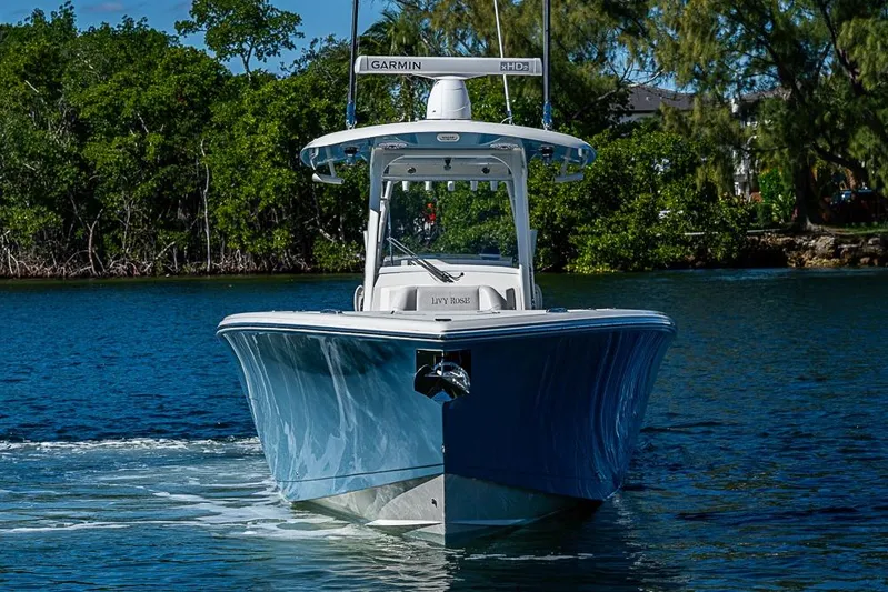 Livy Rose Yacht Photos Pics 2021 Cobia 320 Center Console boat cruising on a scenic waterway.