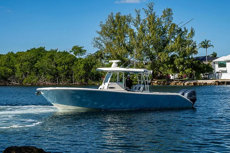 Livy Rose Yacht Photos Pics 2021 Cobia 320 Center Console boat cruising on a scenic waterway.