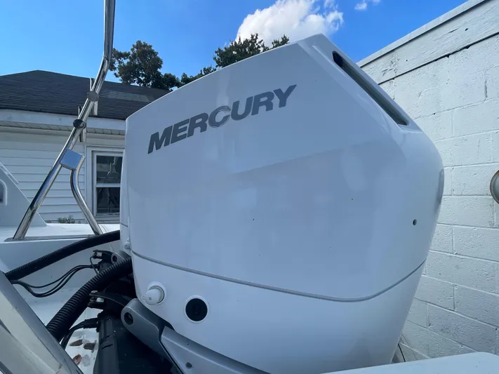  Yacht Photos Pics 2024 Beneteau Gran Turismo 32 with Mercury outboard engine, docked near a white building.