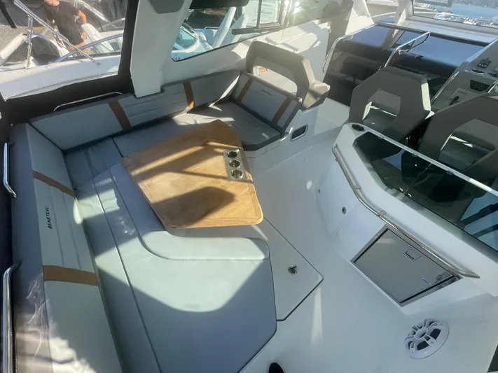 Yacht Photos Pics 2024 Beneteau Gran Turismo 32 interior with modern seating and wooden table.