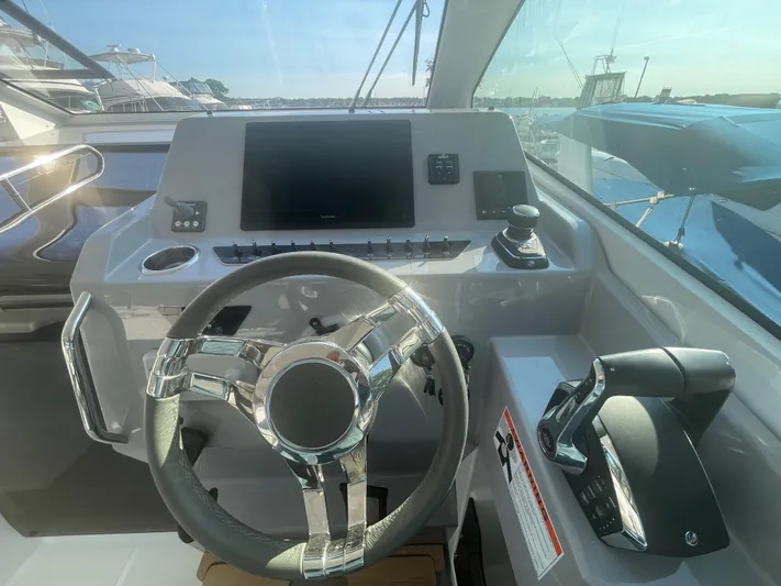  Yacht Photos Pics Helm of 2024 Beneteau Gran Turismo 32 yacht with modern controls and steering wheel.