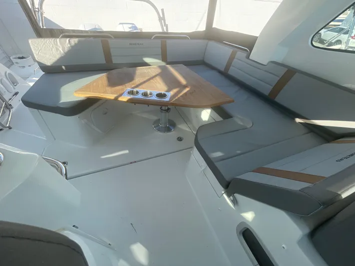  Yacht Photos Pics 2024 Beneteau Gran Turismo 32 interior with sleek seating and wooden table.