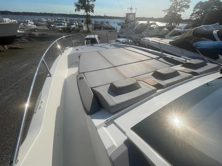  Yacht Photos Pics 2024 Beneteau Gran Turismo 32 yacht with sun deck, docked at marina.