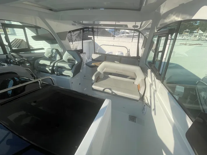  Yacht Photos Pics 2024 Beneteau Gran Turismo 32 interior with modern seating and helm station.
