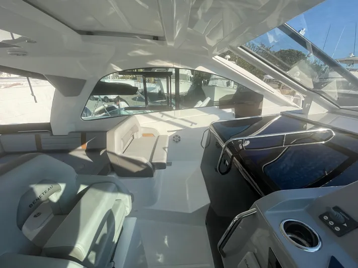  Yacht Photos Pics 2024 Beneteau Gran Turismo 32 interior with modern helm and seating area.