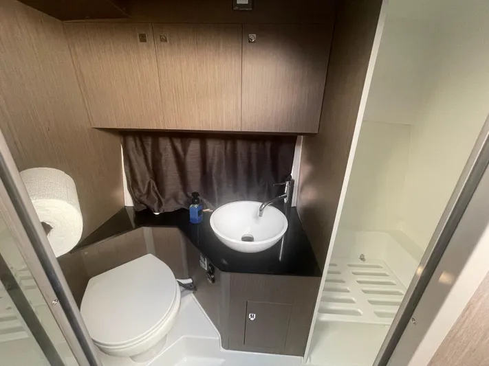  Yacht Photos Pics 2024 Beneteau Gran Turismo 32 bathroom with modern fixtures and compact design.