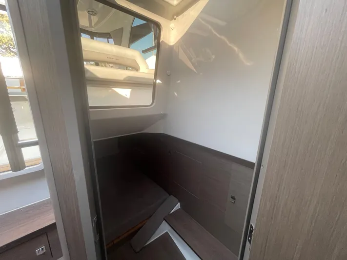  Yacht Photos Pics 2024 Beneteau Gran Turismo 32 cabin interior with modern wood finish and window.